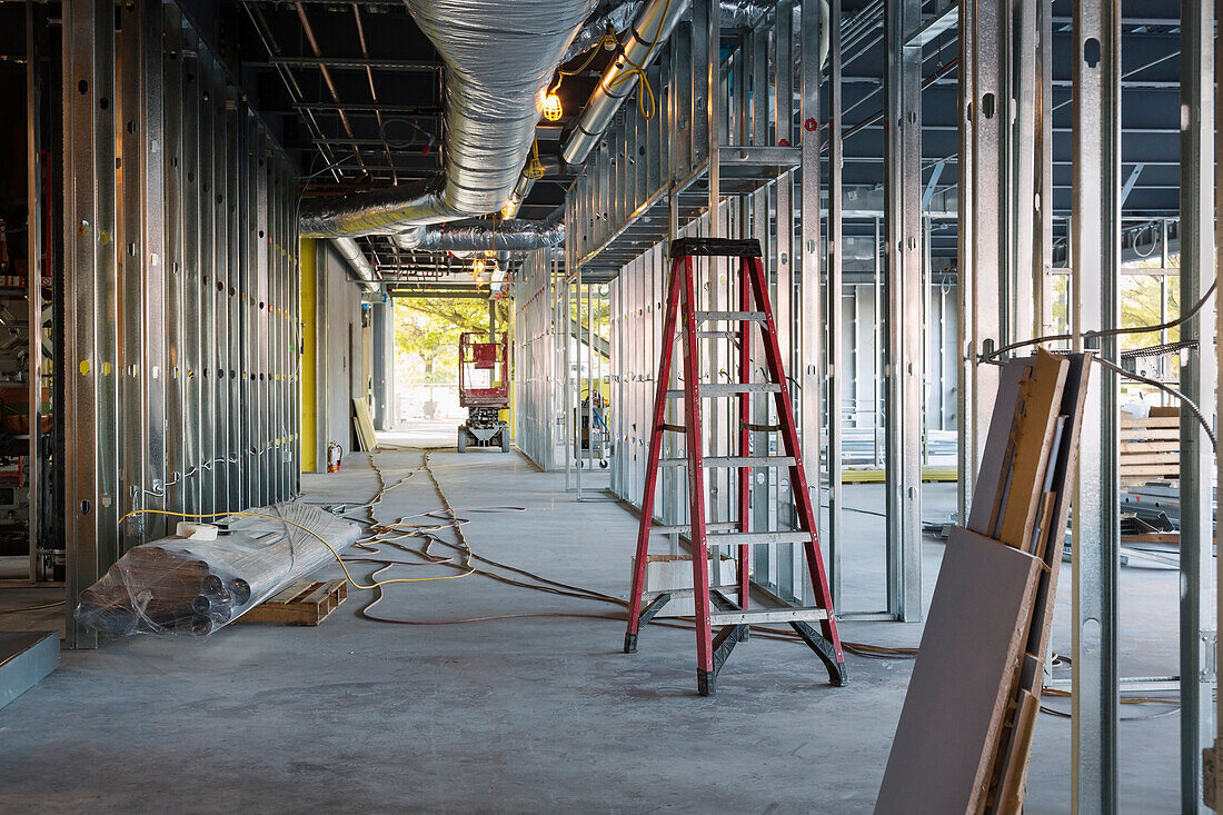 Commercial building under construction with metal stud framing and ductwork